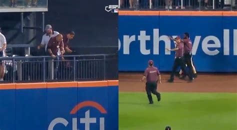 mets fan falls onto field|mets giants fall.